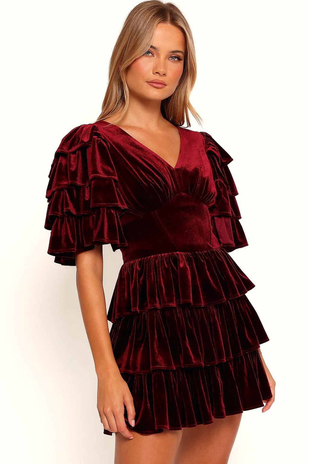 Front view of a wine velvet mini dress with a tiered ruffle skirt