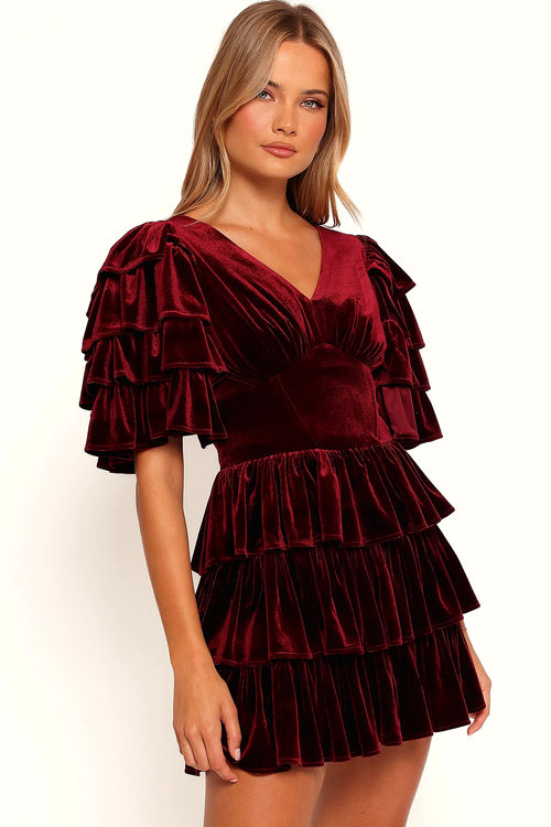 Front view of a wine velvet mini dress with a tiered ruffle skirt