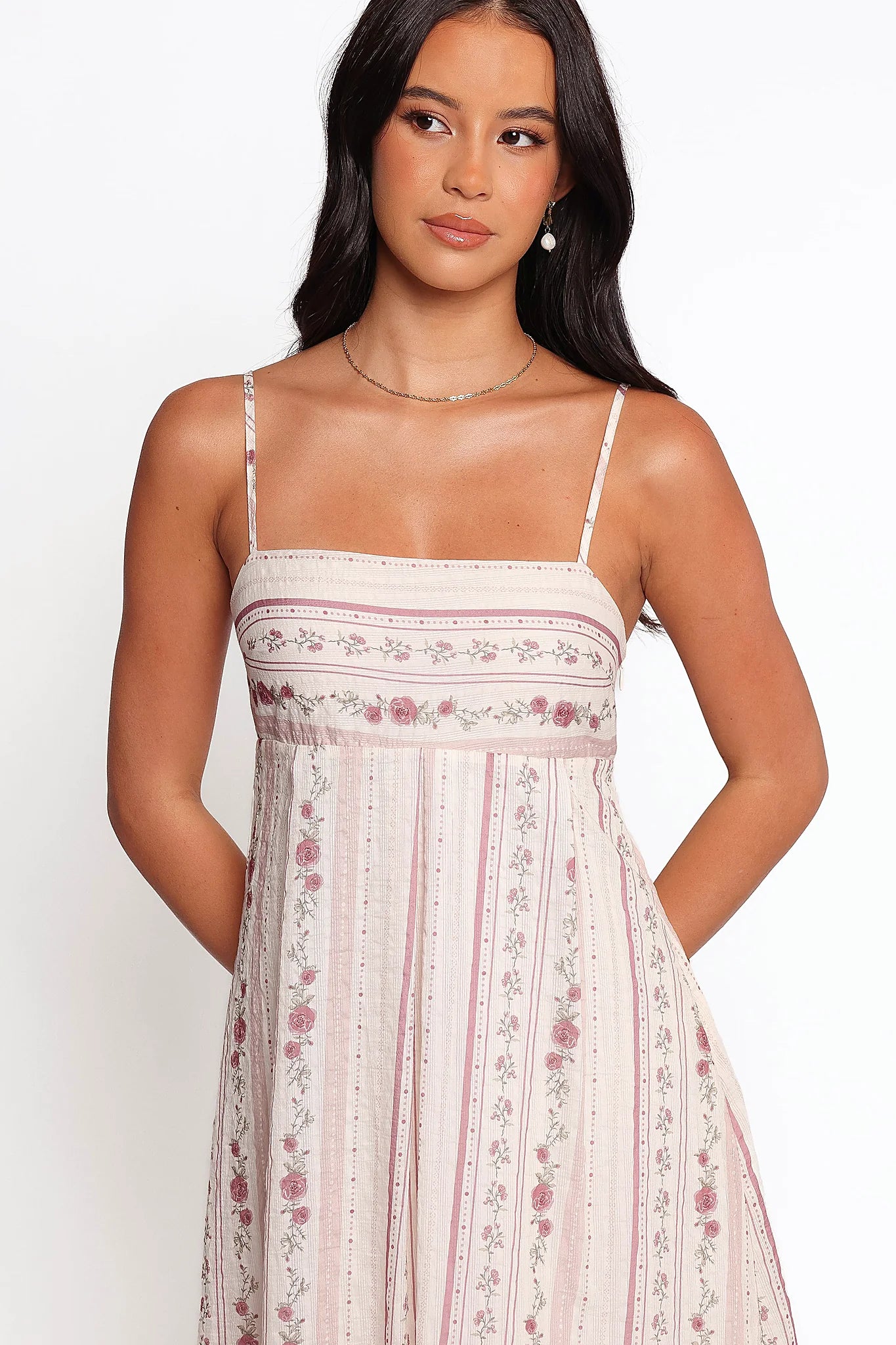 Side view showing the long skirt falling from the high waist
