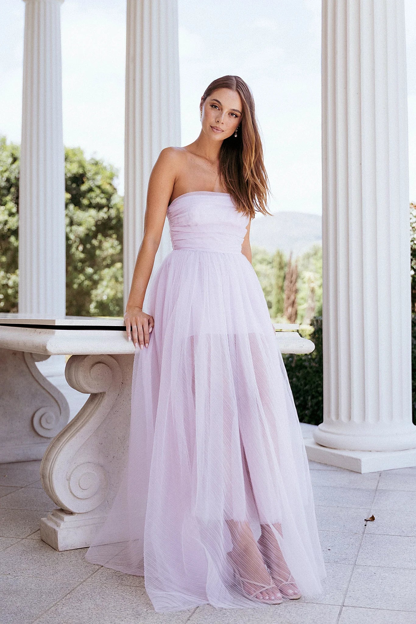 Front view of a pale pink strapless maxi dress in tulle mesh