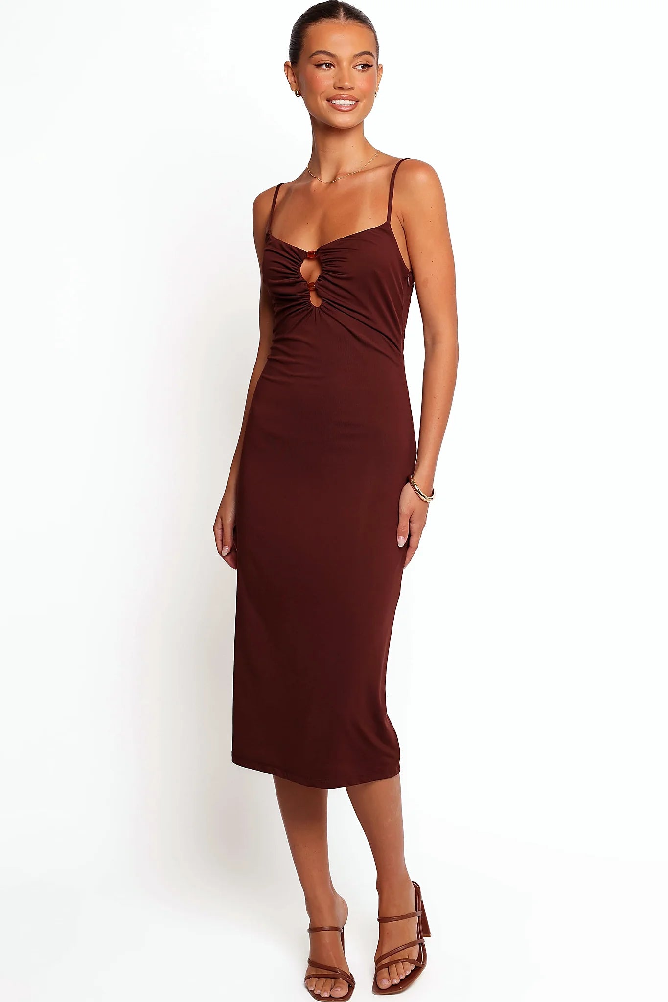 Front view of a brown bodycon midi dress with a beaded front cut-out