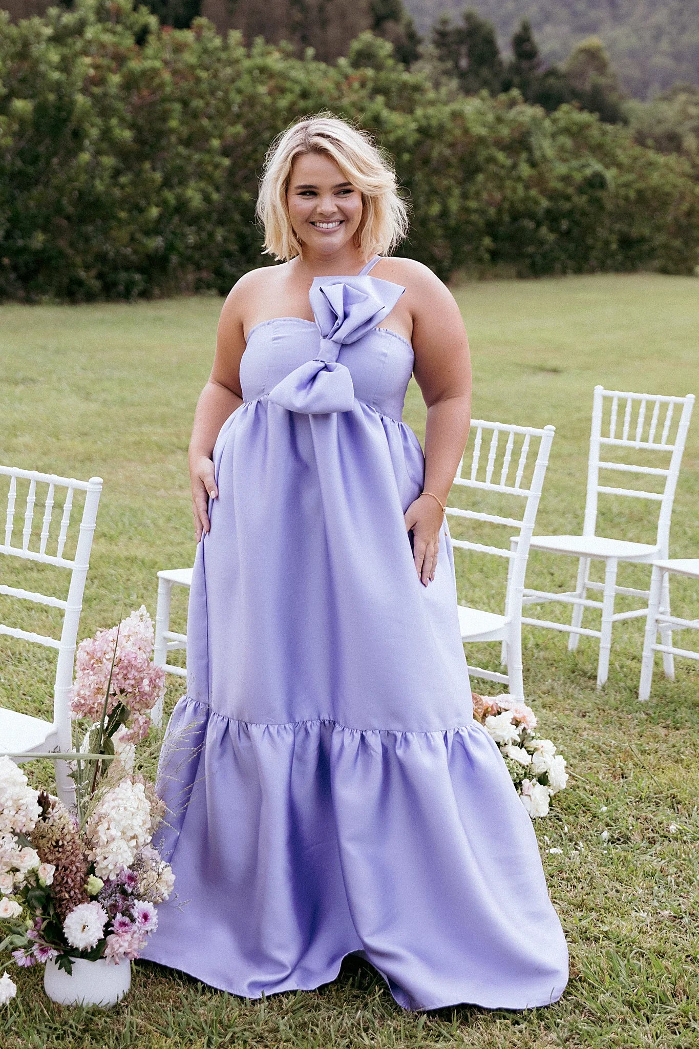 Front view of a one shoulder maxi dress with a bow at the front