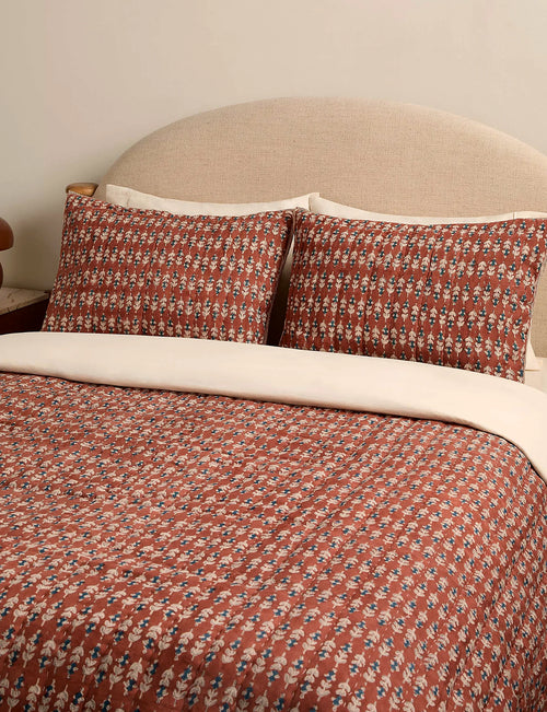 Pair of block print shams in a sierra colourway on a made bed