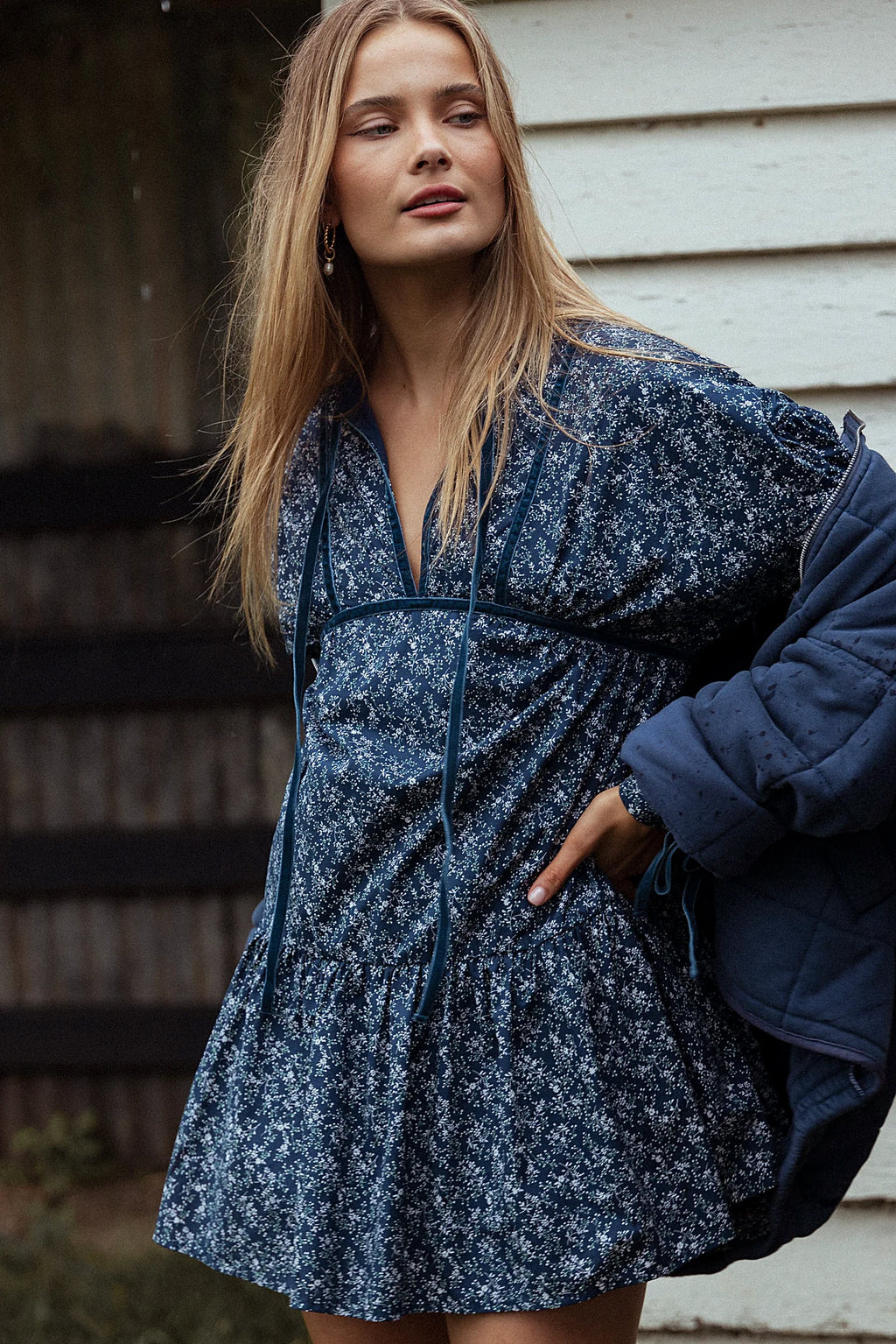 Front view of a blue floral mini dress with a deep V cut-out
