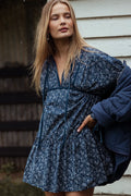 Front view of a blue floral mini dress with a deep V cut-out