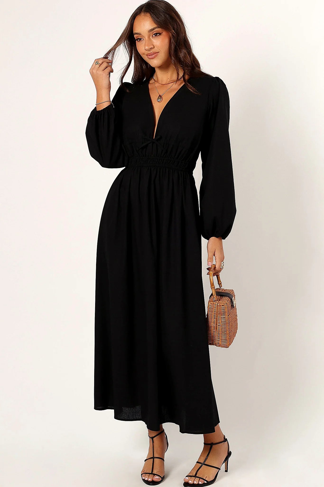 Front view of a black linen maxi dress with a deep V neckline