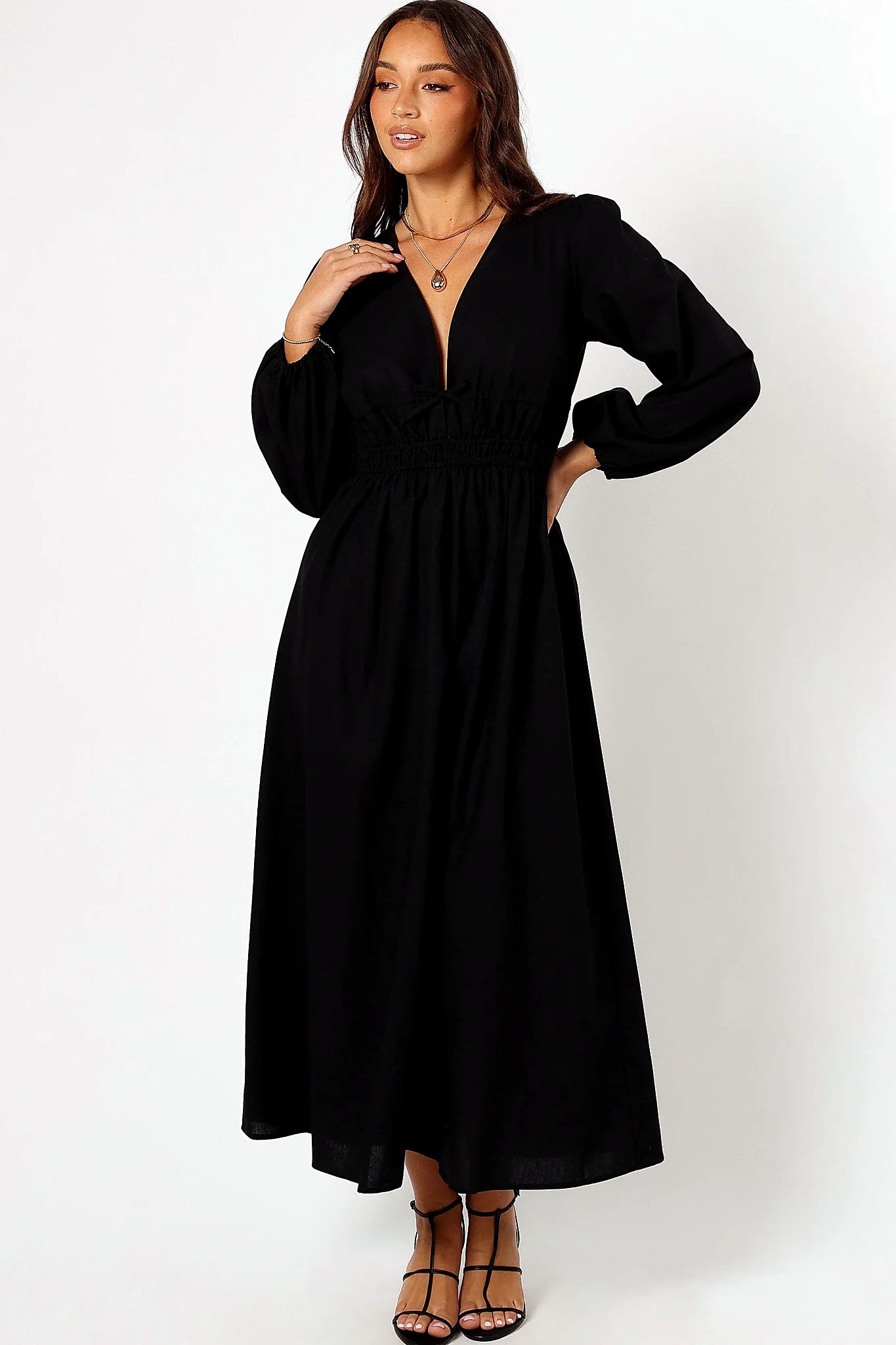 Side view showing the A-line skirt falling to the floor