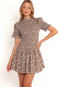 Front view of a floral cotton mini dress with a shirred bodice