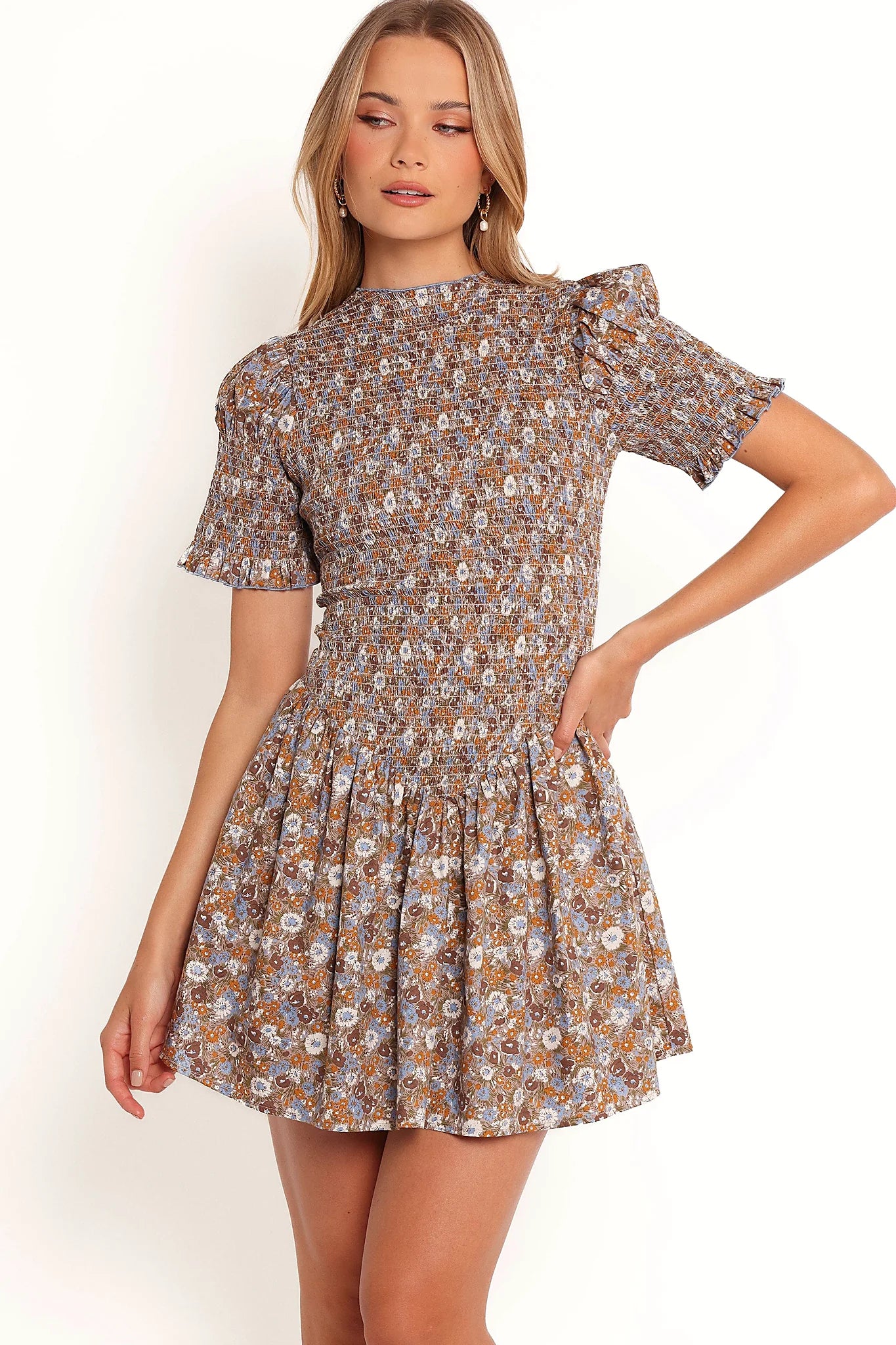 Front view of a floral cotton mini dress with a shirred bodice