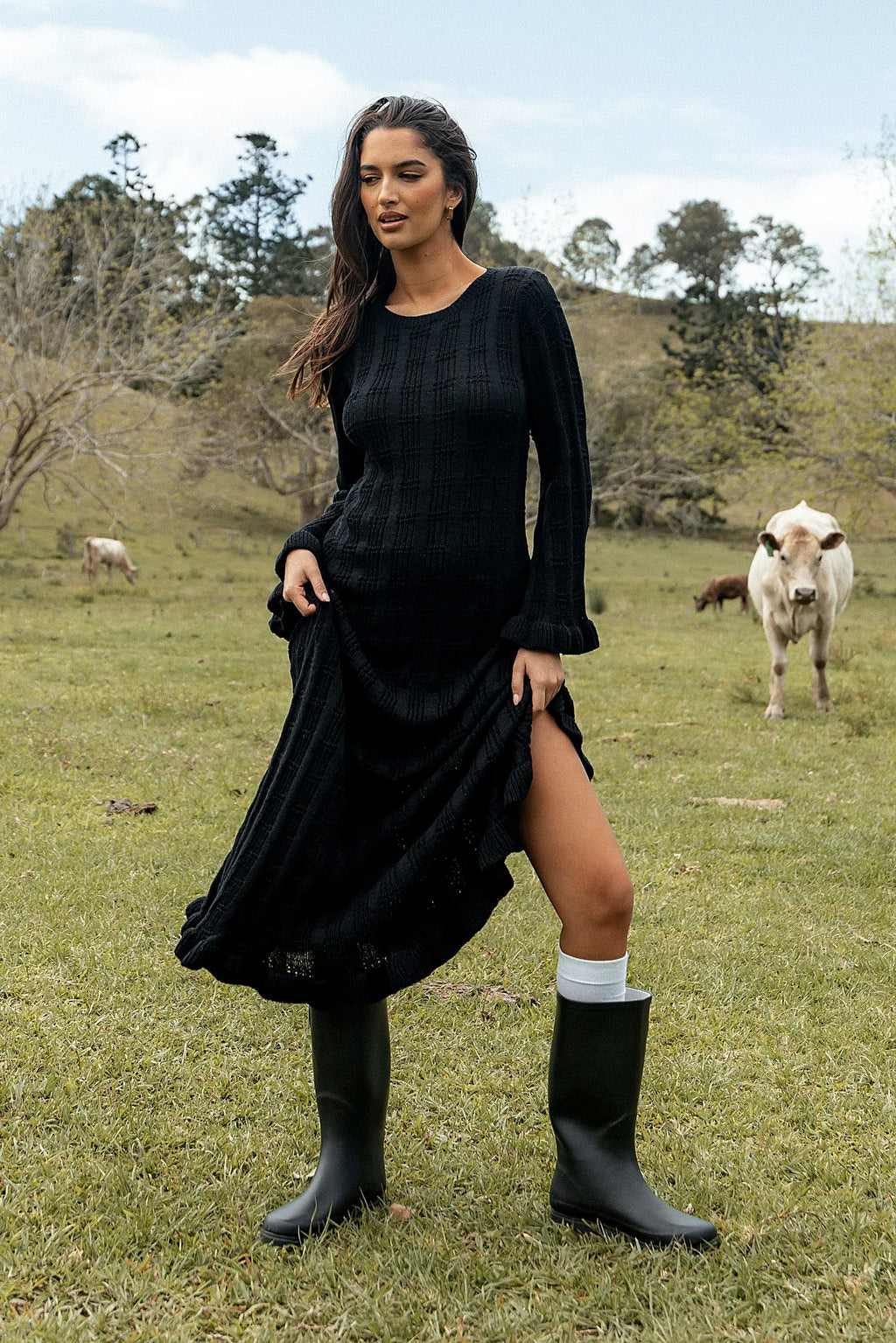 Front view of a black ribbed knit maxi dress with long sleeves