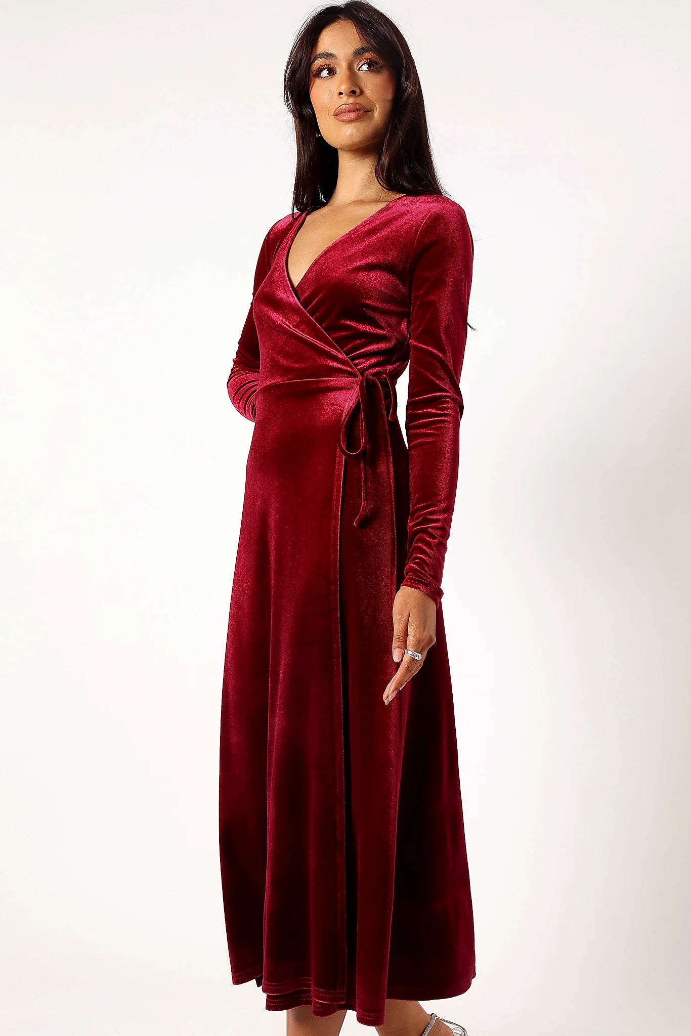 Front view of a wine velvet wrap midi dress with a V overlay neckline