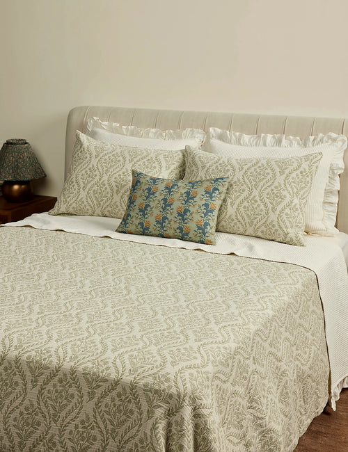 Sage botanical coverlet in queen size styled on a made bed