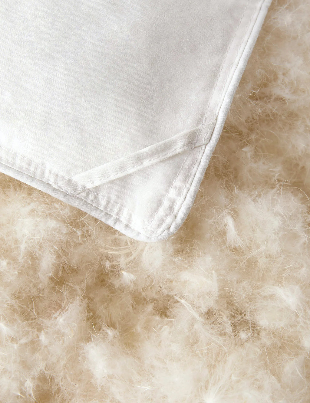 Close view of the fill in a full queen down duvet insert