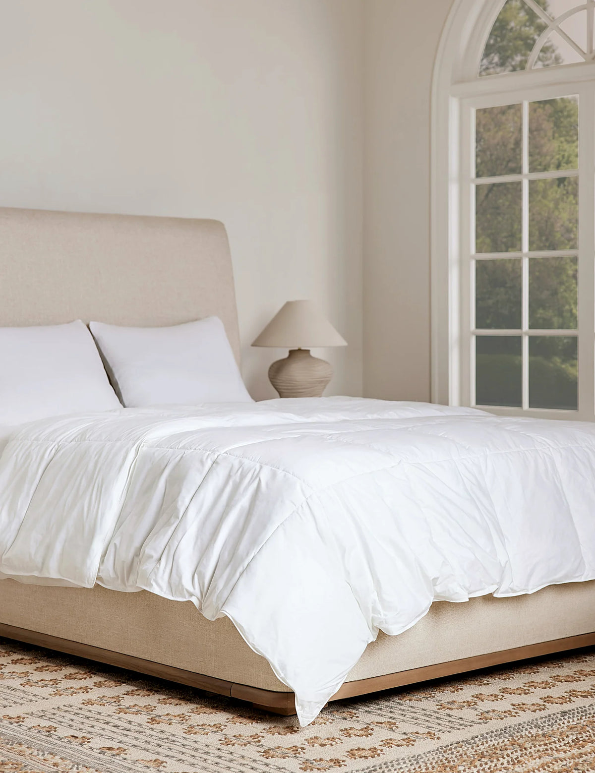 Made bed showing the loft a down duvet insert gives under a cover
