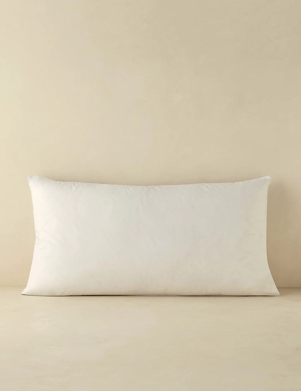 King size down pillow insert photographed against a plain ground