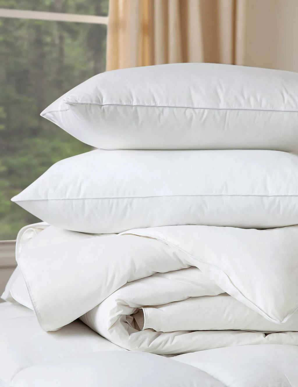 Made bed layered with down inserts under the covers