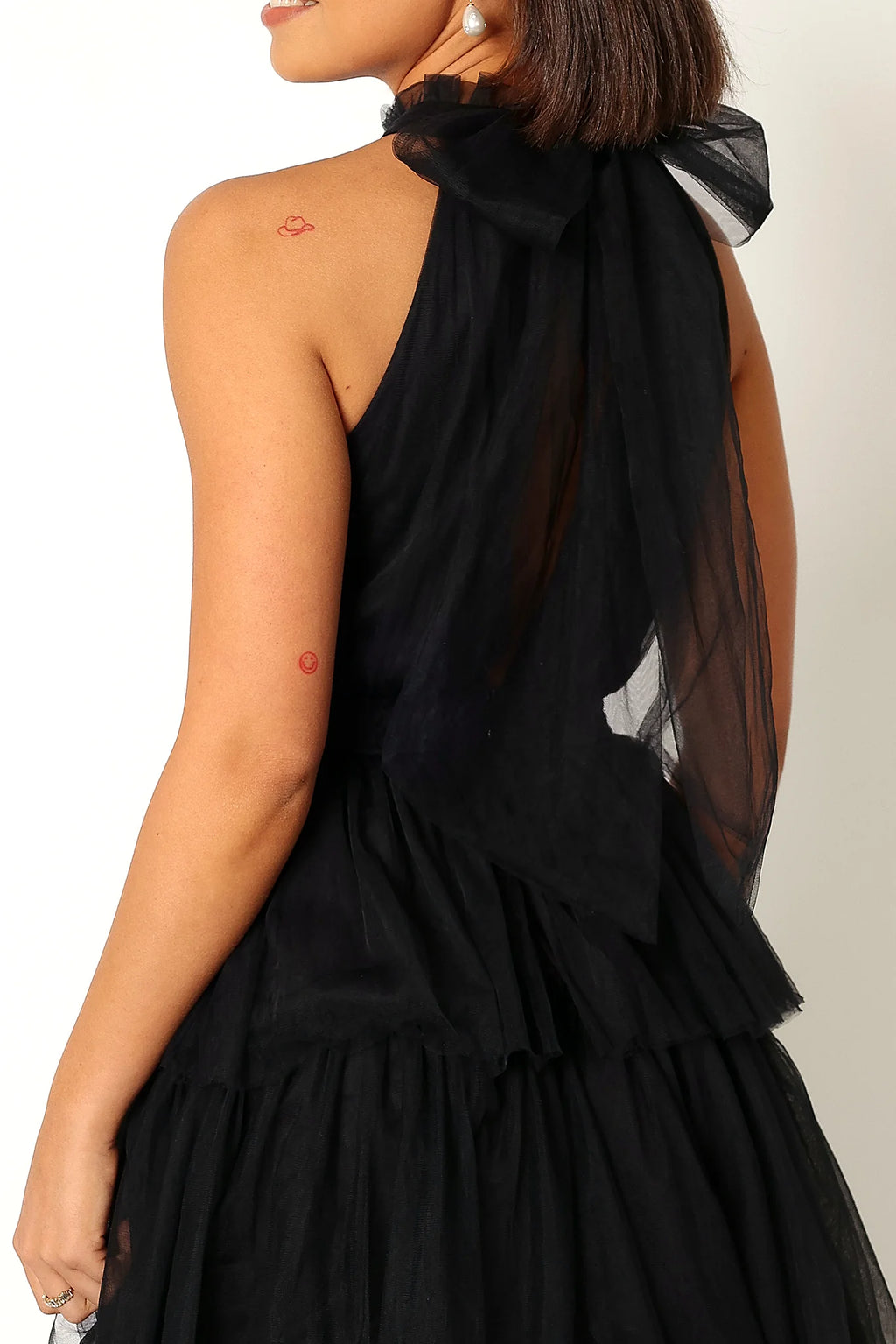 Back view showing the open back and halter tie close