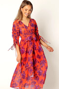 Front view of a red floral midi dress with long sleeves