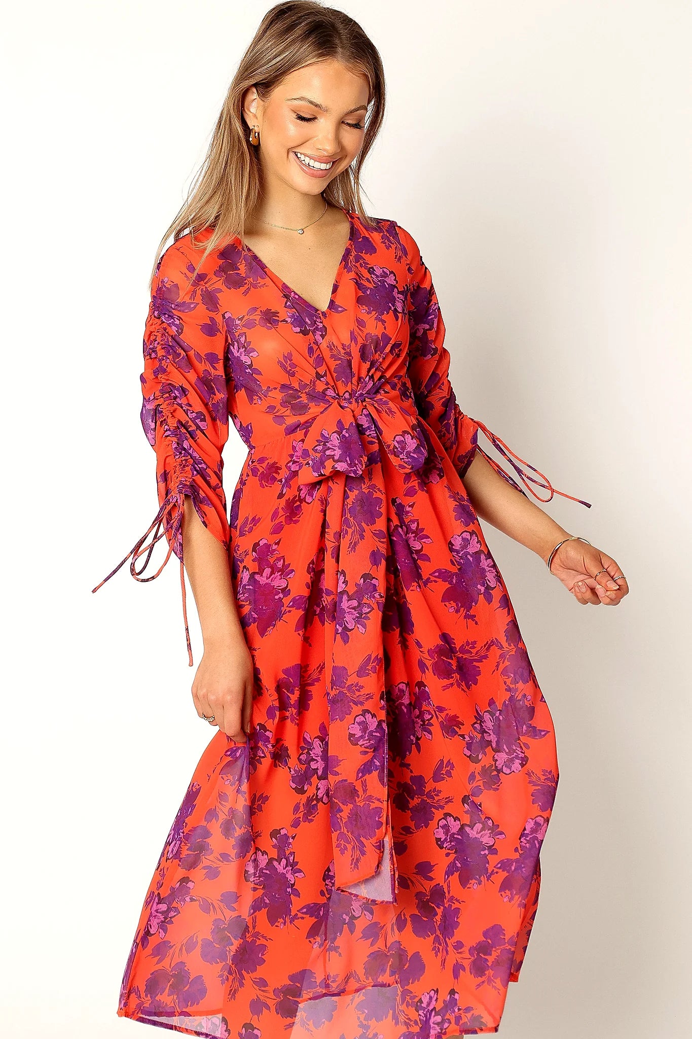 Front view of a red floral midi dress with long sleeves