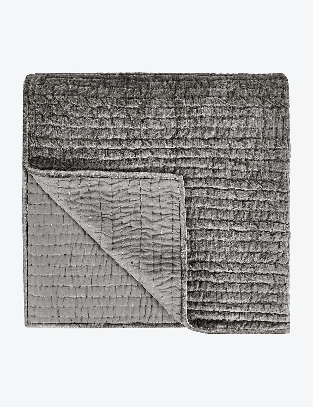 Another view of the linear quilted velvet quilt in a muted tone