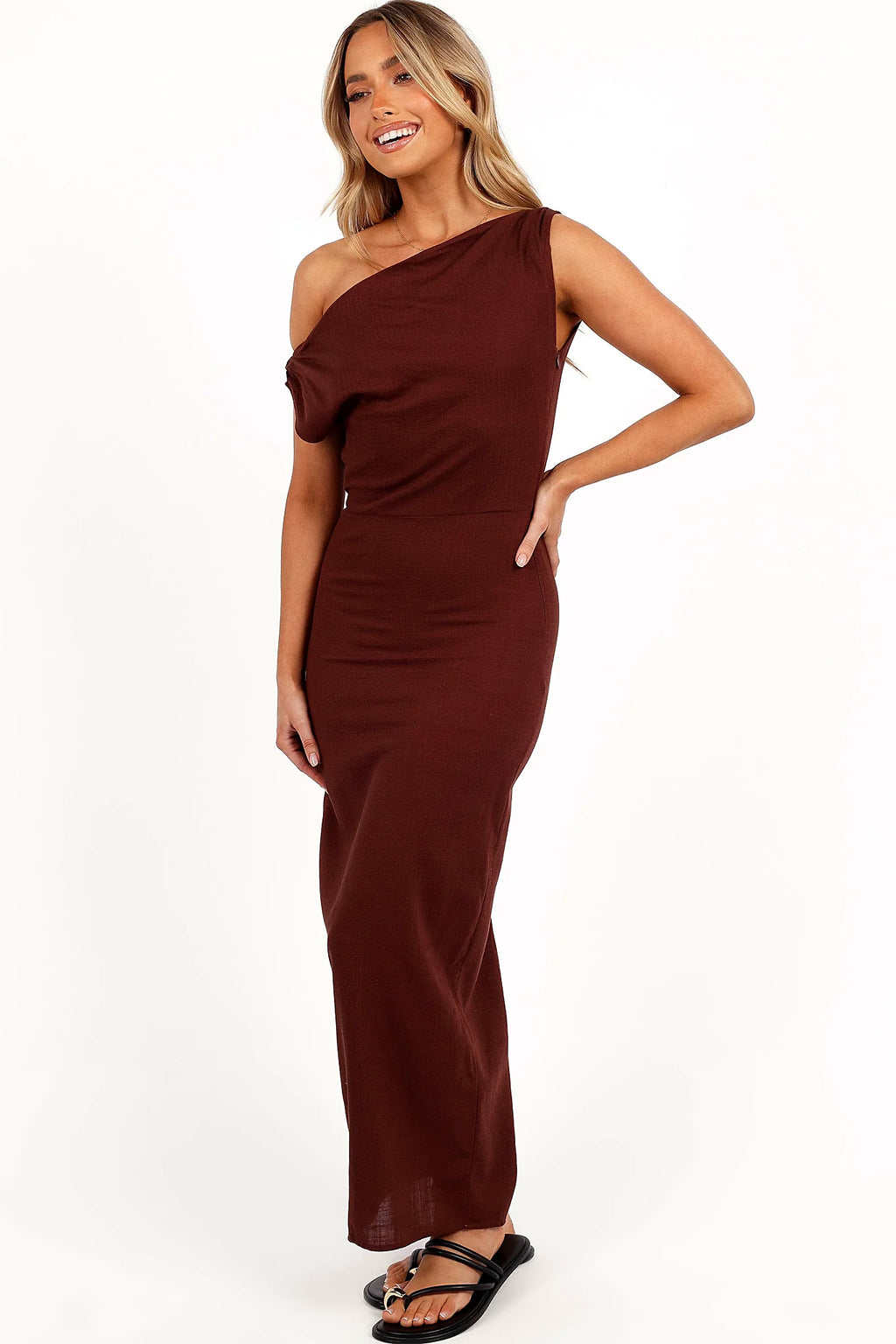 Front view of a brown linen maxi dress with an asymmetric off-shoulder neckline