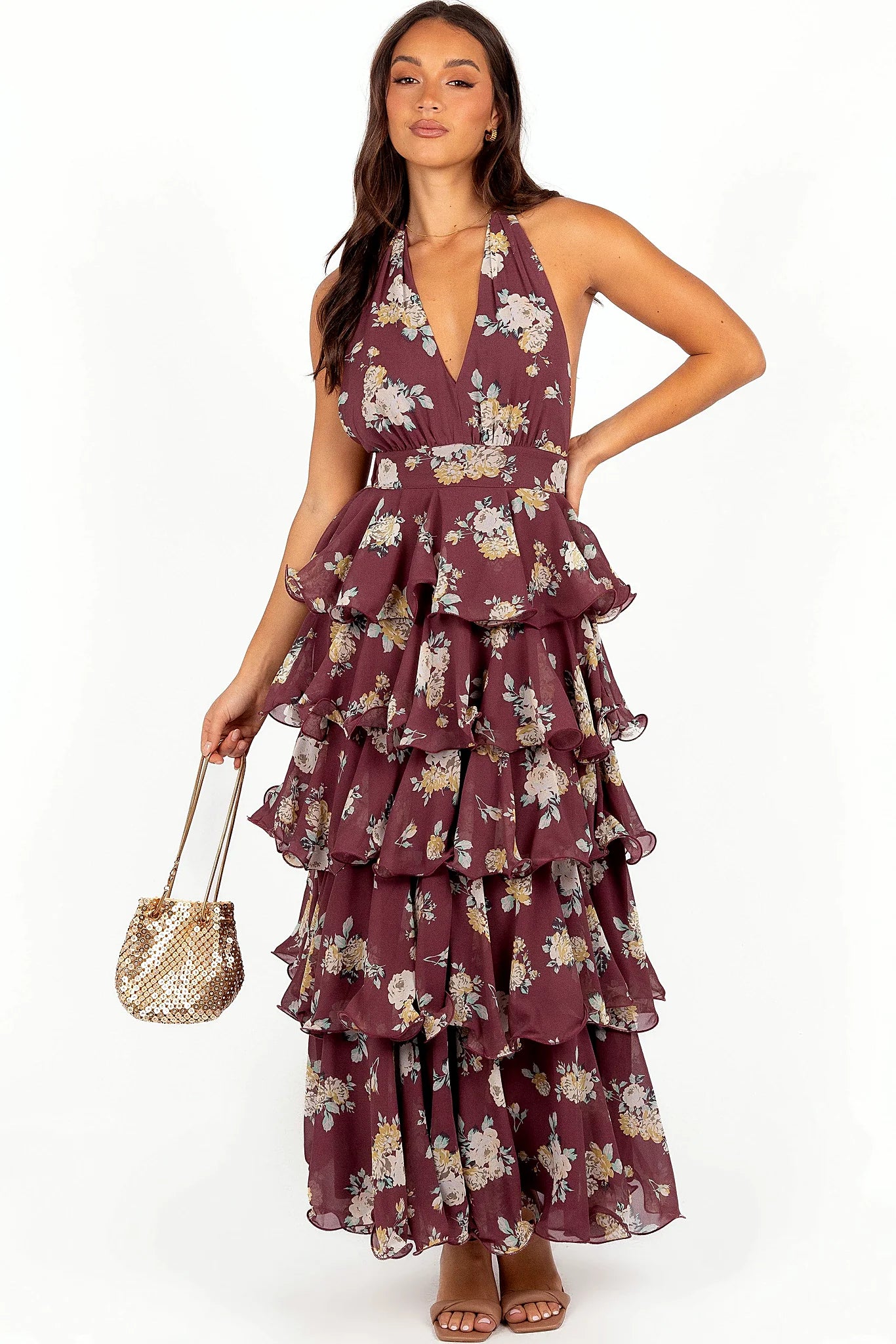 Front view of a wine halterneck maxi dress with a floral print tiered skirt