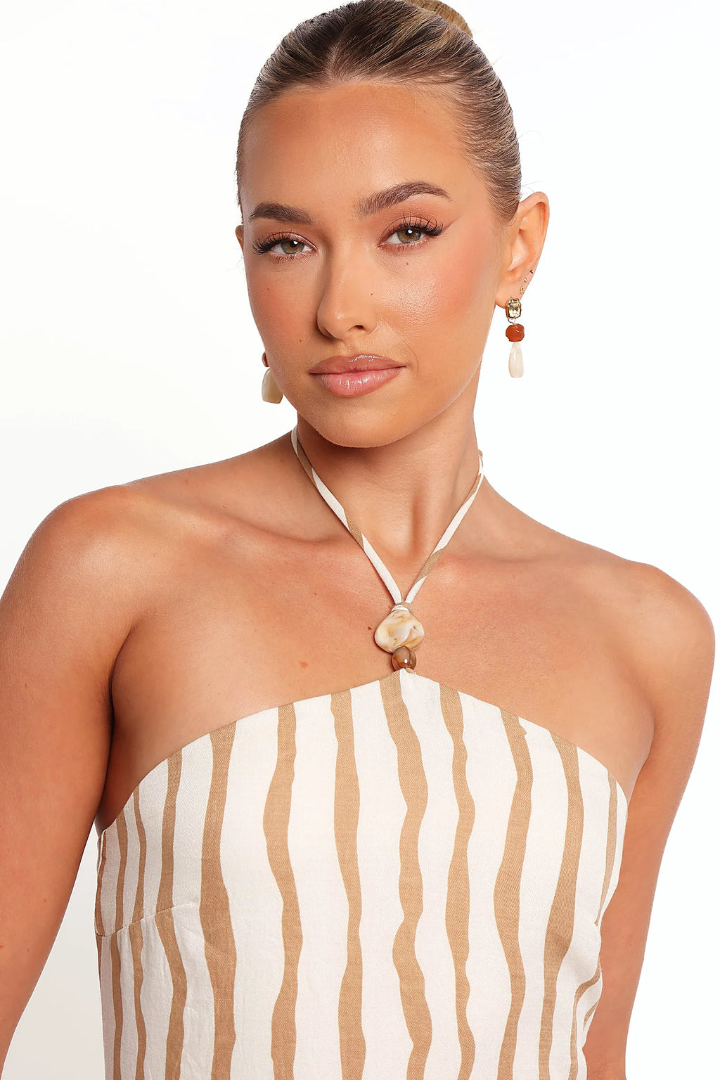 Side view of the striped maxi dress falling to the floor