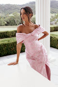 Front view of a pink strapless maxi dress with an oversized bow