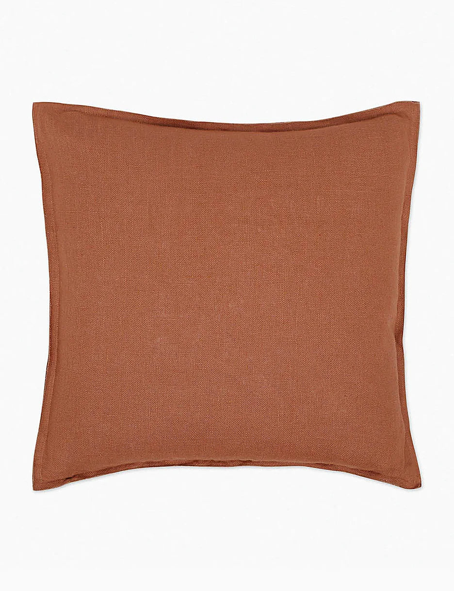 Linen lumbar pillow photographed flat against a plain ground