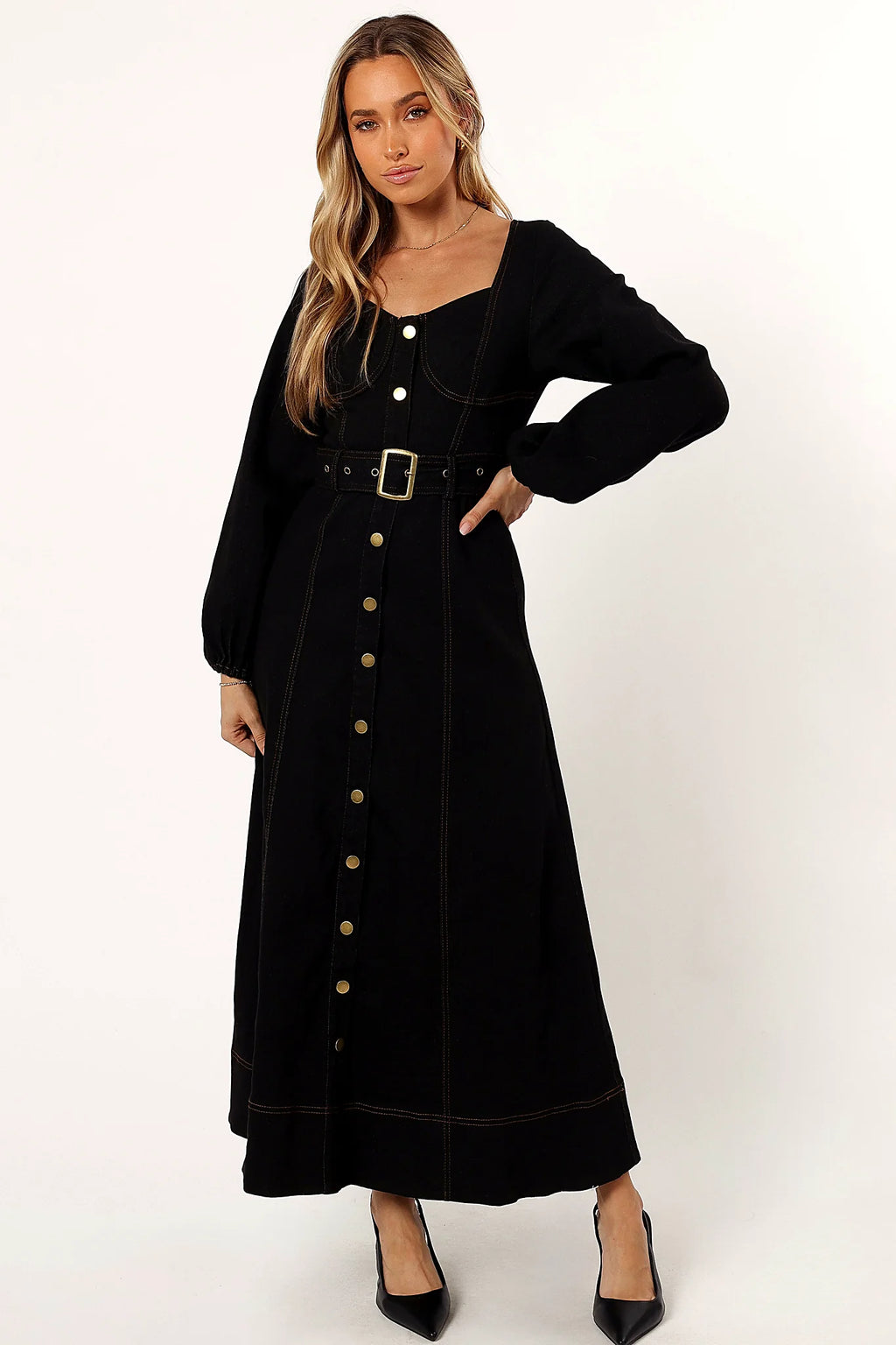 Front view of a black maxi dress with a buckle belt at the waist
