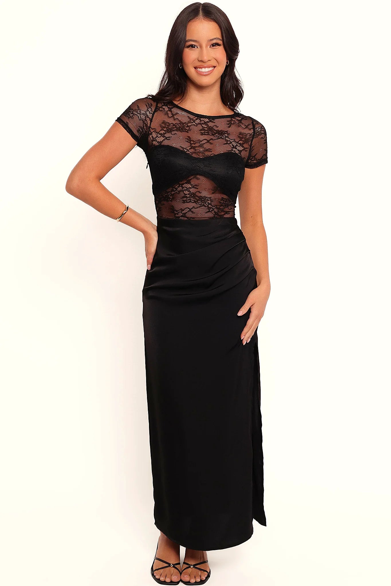 Front view of a black midi dress with a lace overlay and round neck