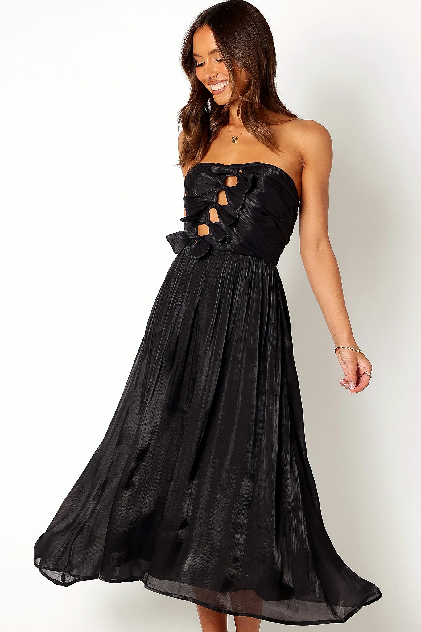 Front view of a black strapless midi dress with a bow on the bodice