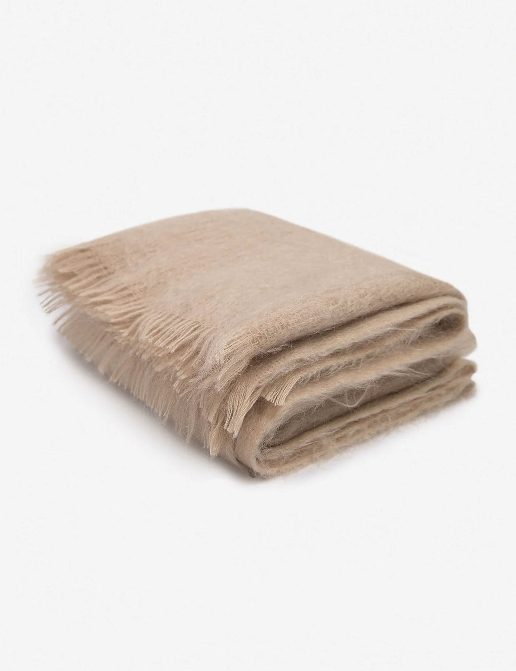 Blush mohair wool throw photographed against a plain ground