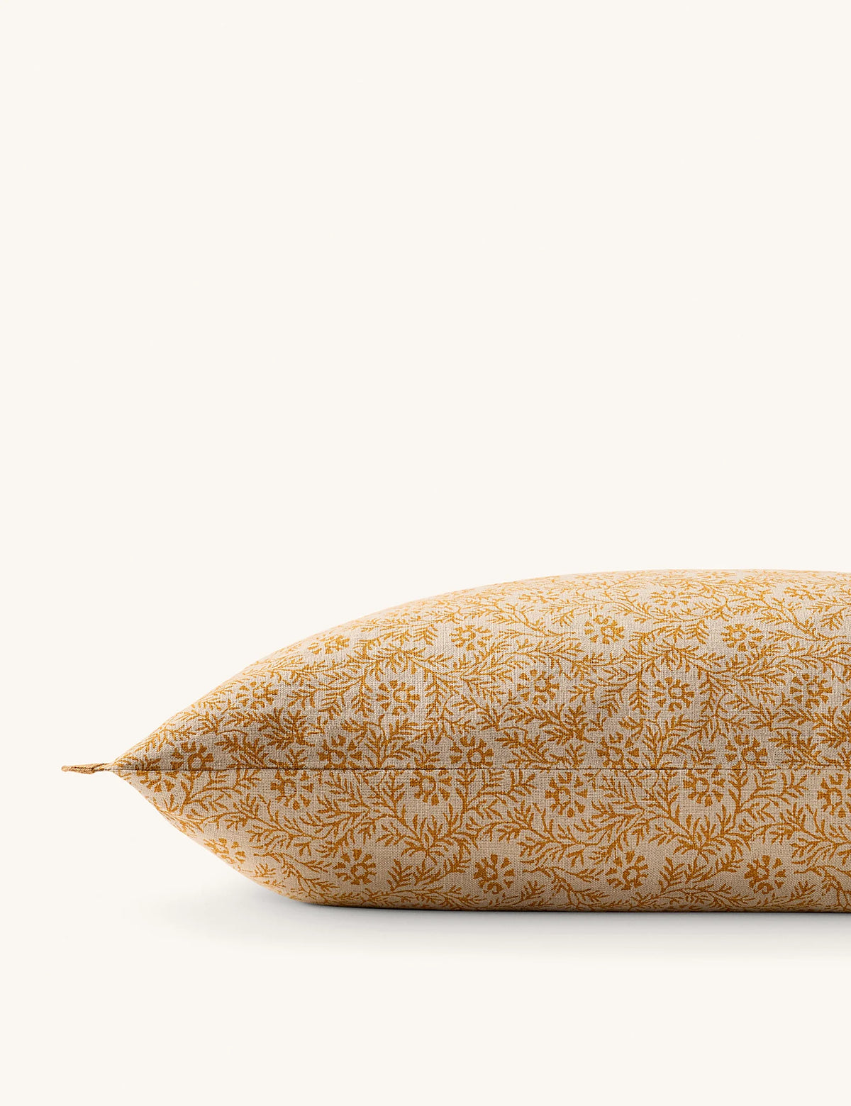 Angled view of the floral pattern and tailored trim on a linen pillow