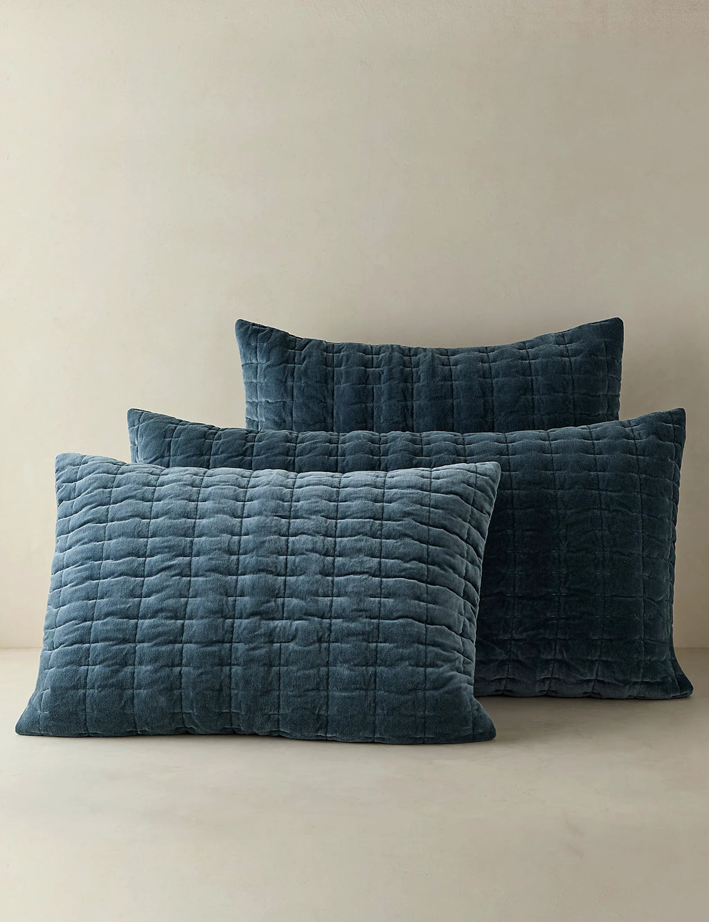 Group shot of quilted velvet shams in several colourways