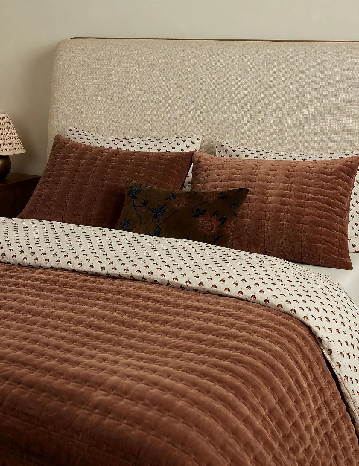 Rosewood quilted velvet sham in standard size on a made bed