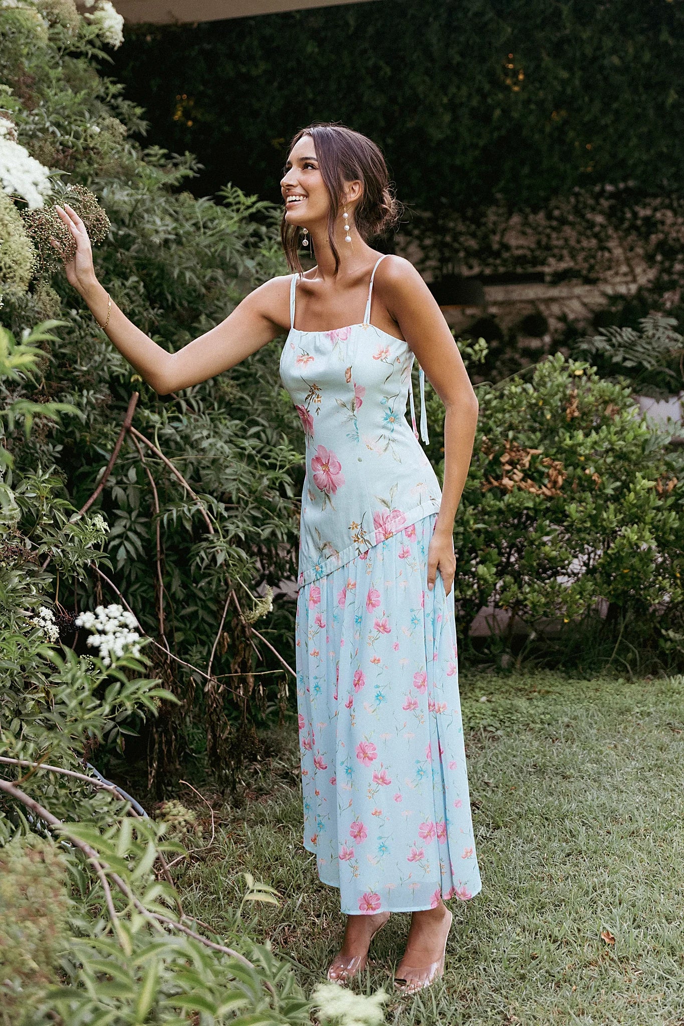 Front view of a blue floral maxi dress with an asymmetric top hemline