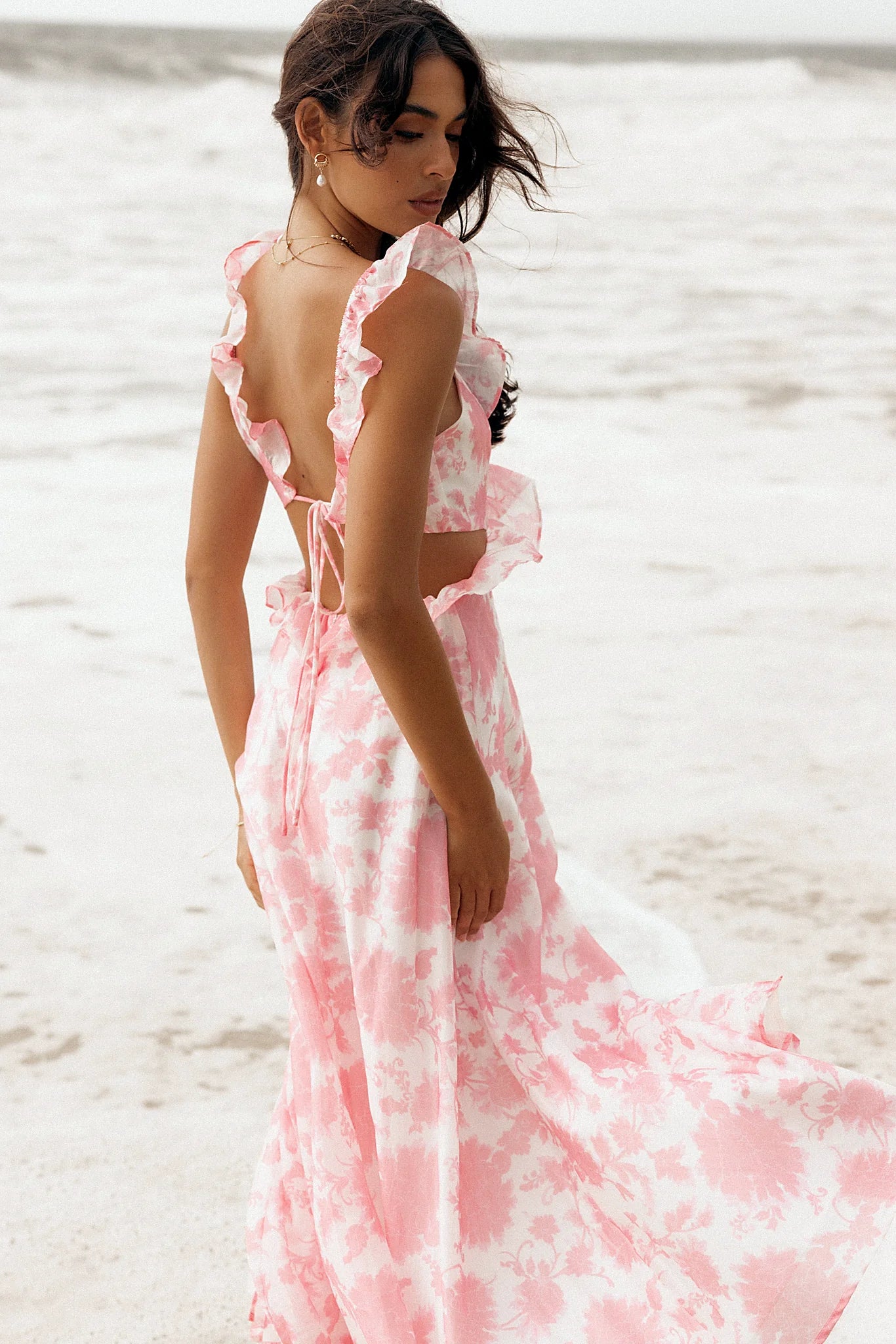 Front view of a pink floral maxi dress with a ruffled V neckline
