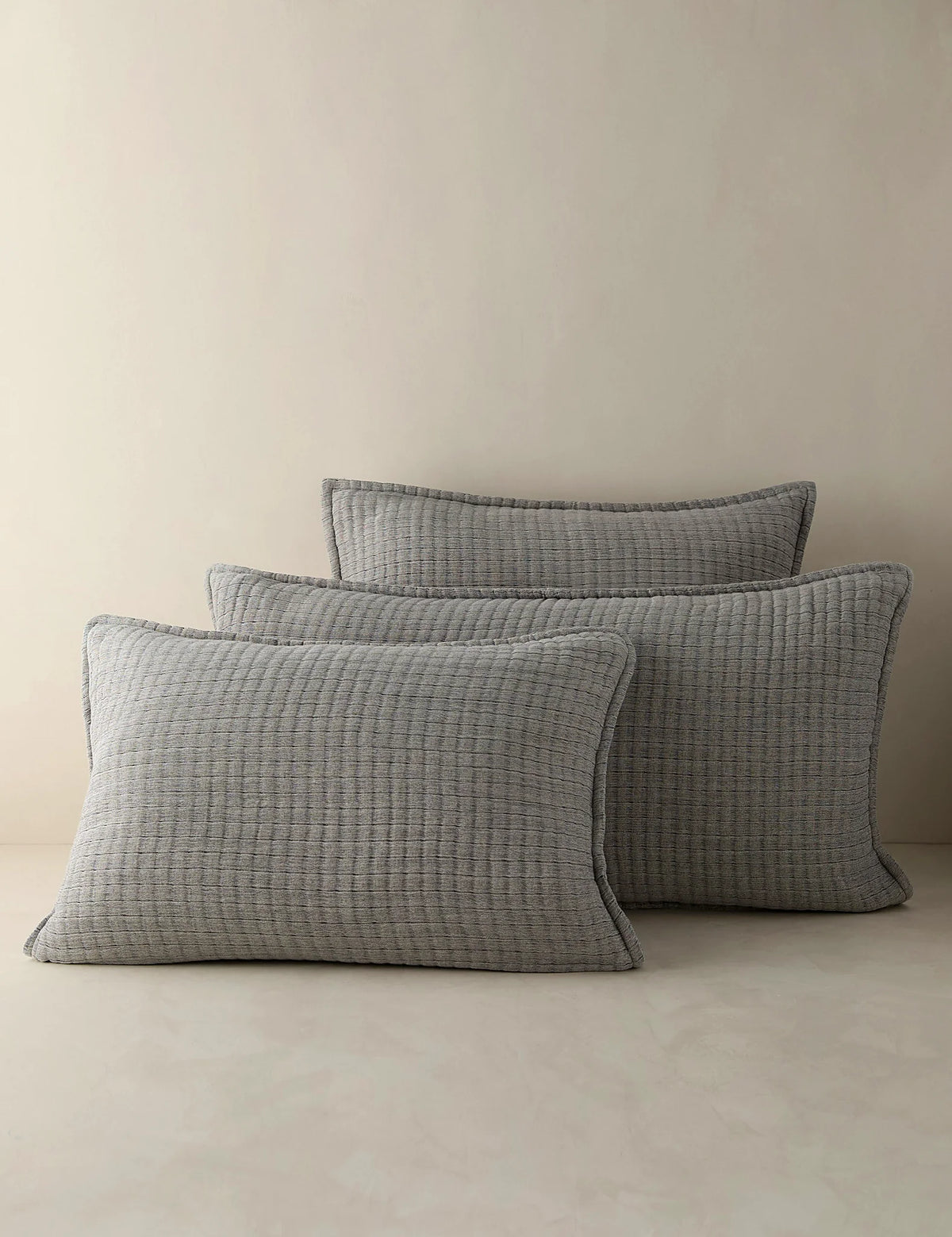 Group shot of dusty blue quilted cotton shams in two sizes
