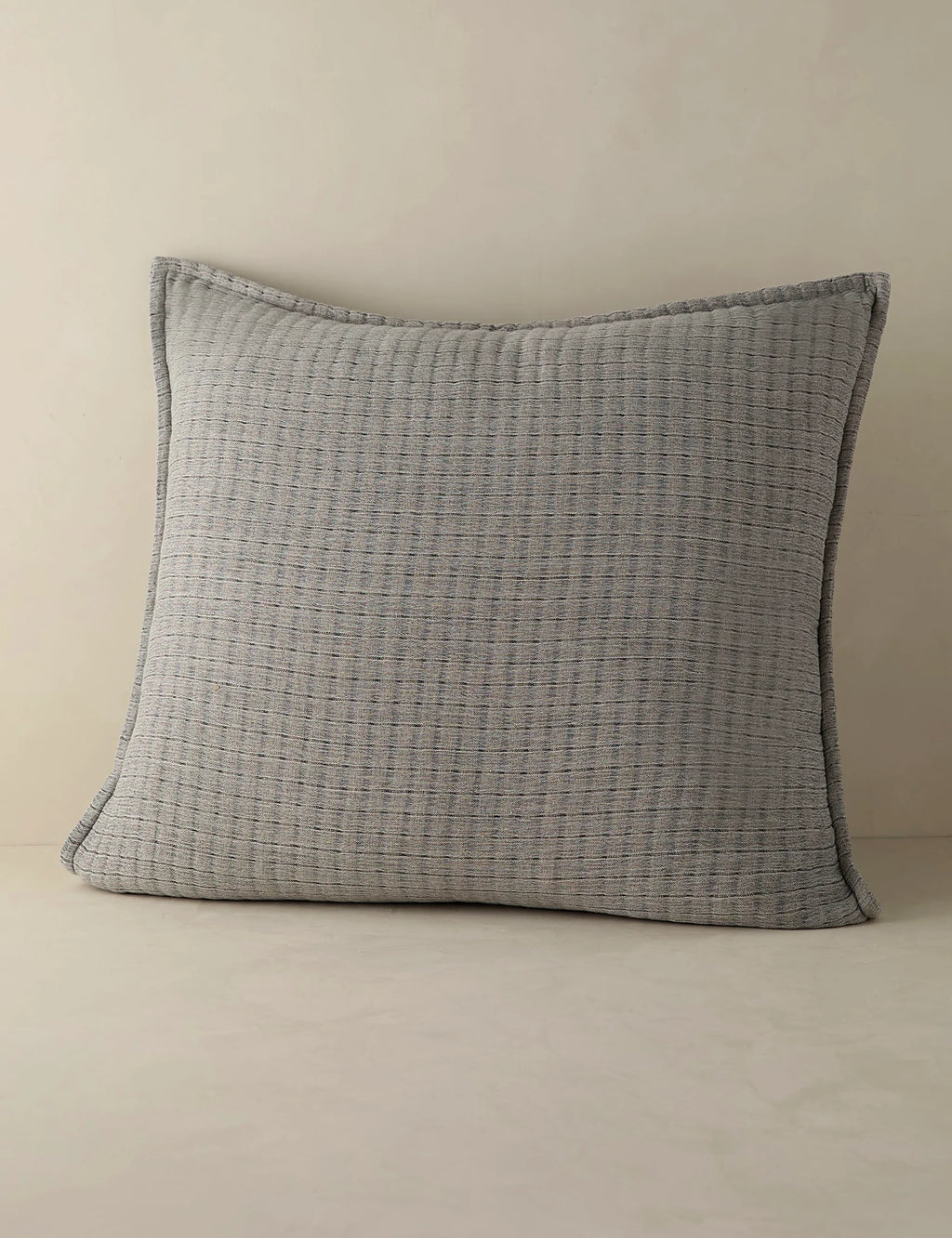 Euro size quilted cotton sham shown against a plain ground