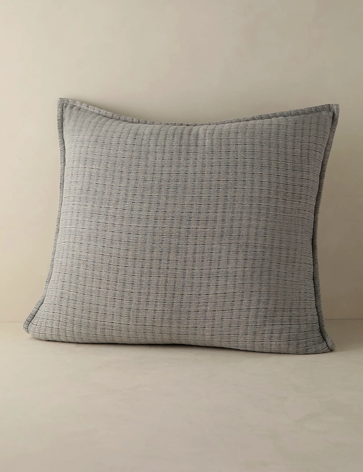 Euro size quilted cotton sham shown against a plain ground