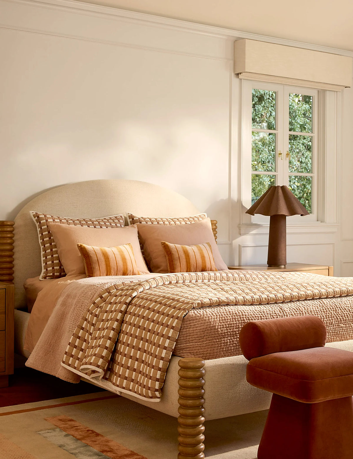 Bedroom with plush quilted velvet shams at the head of the bed