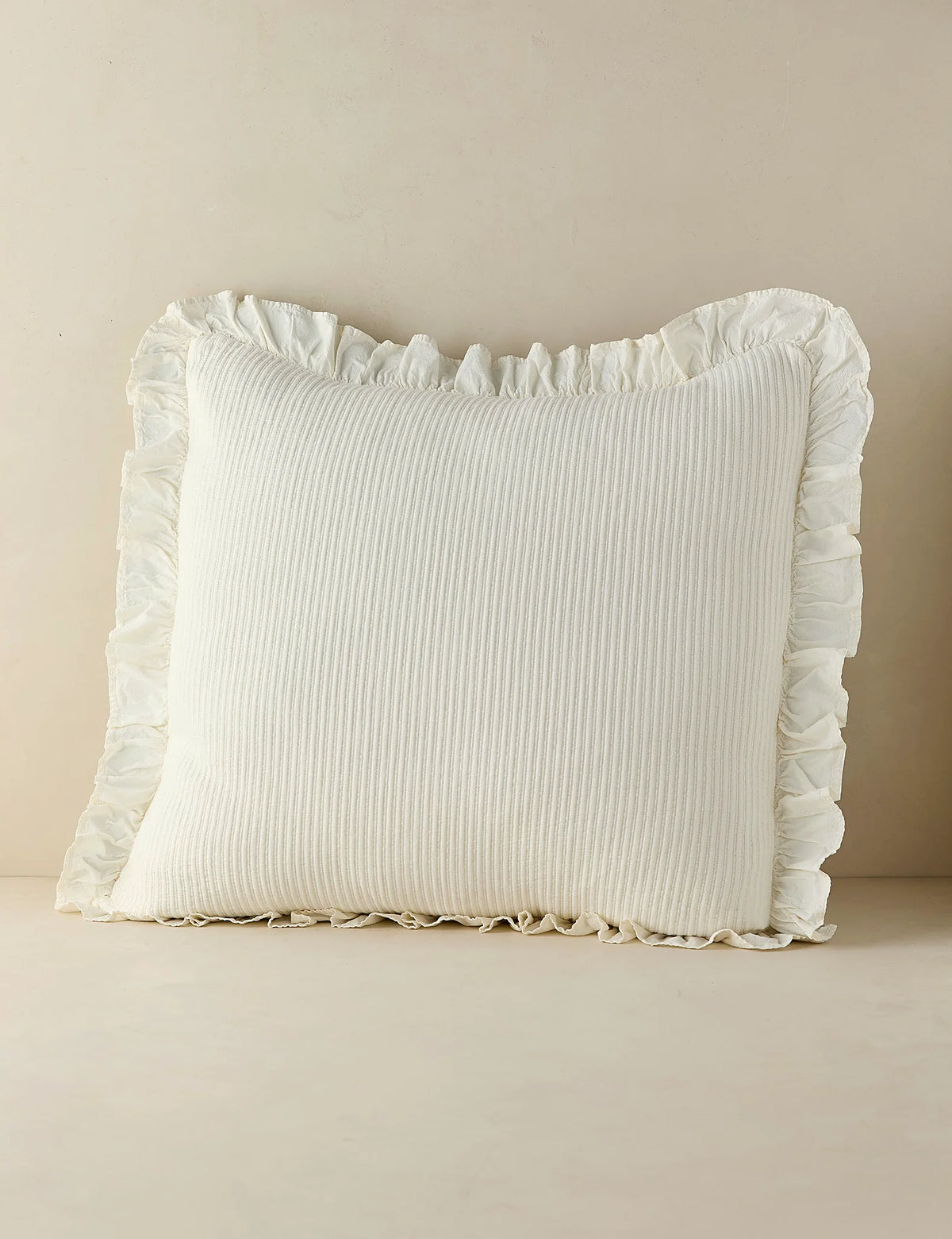 Ivory cotton sham in euro size photographed against a plain ground