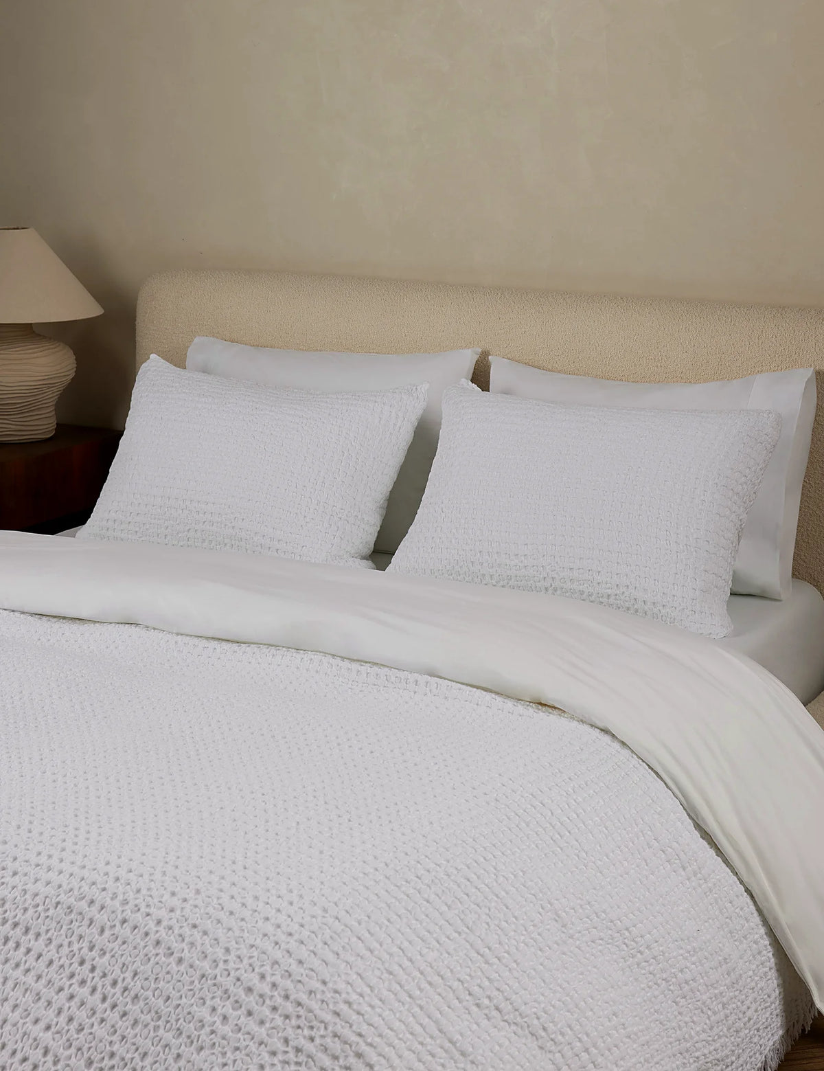 White textured cotton sham shown alongside the blanket