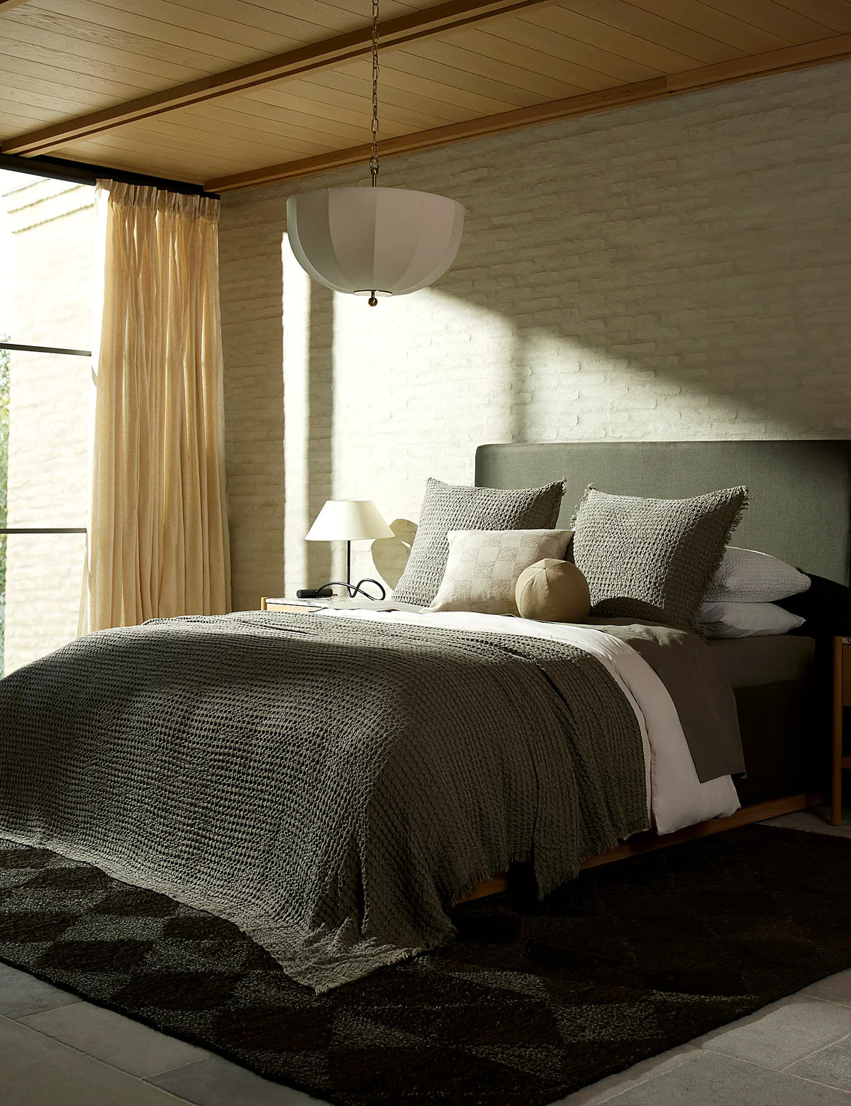 Textured cotton-linen blanket layered over a bed in a bedroom
