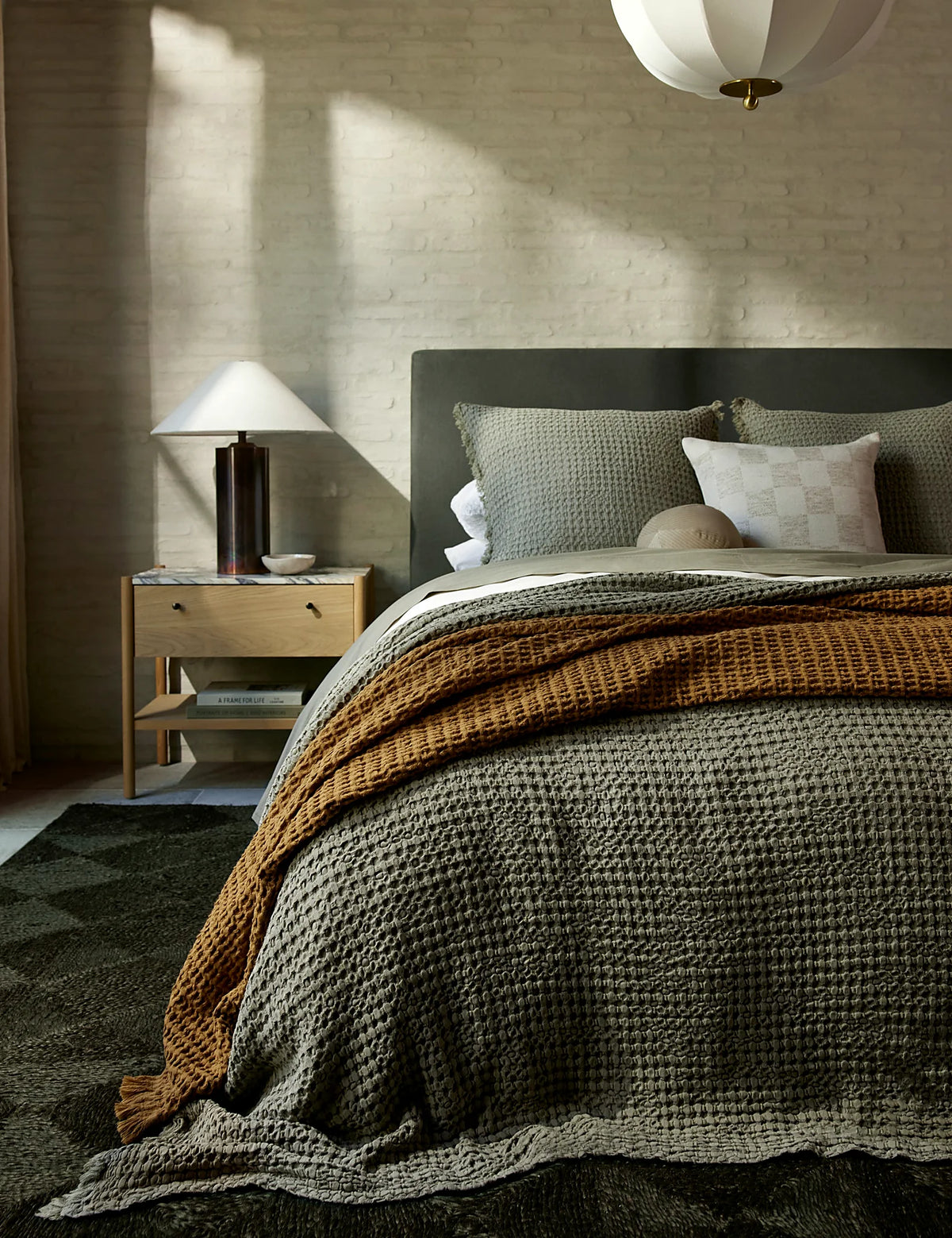 Bedroom with a textured cotton-linen sham layered at the head of the bed