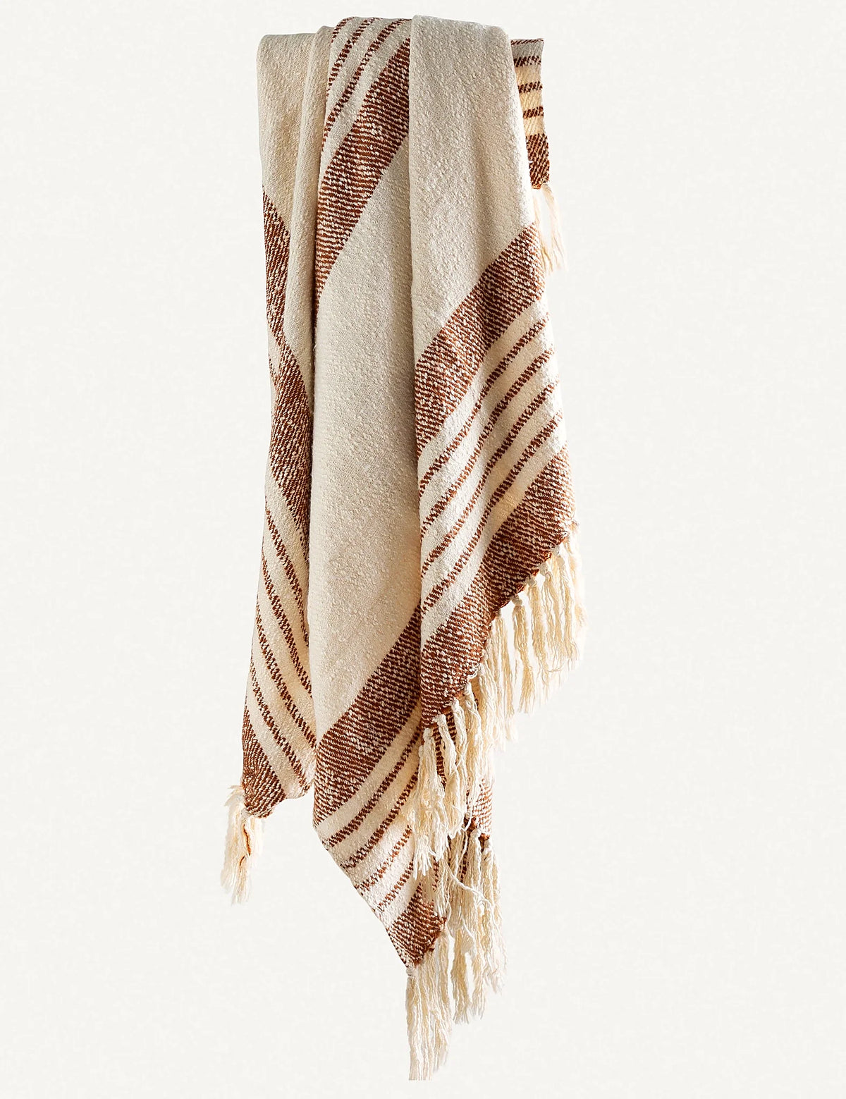 Styled shot of a two-tone striped throw in a living room